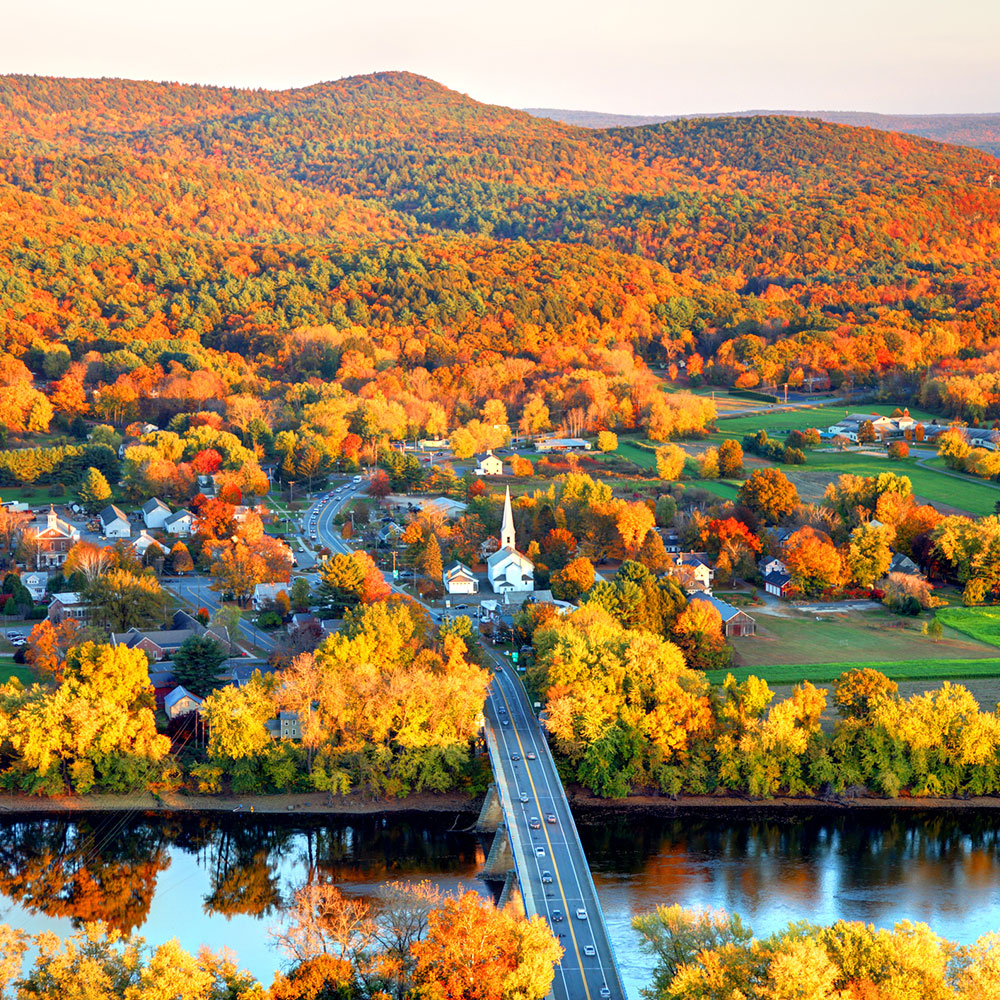 Connecticut River winding through the Poineer valley region of Massachusetts. Photo taken from a scenic viewpoint on Sugurloaf Mountain in Sunderland at dusk. The Pioneer Valley is known for its scenery and as a vacation destination and its beautiful fall foliage ranks with the best in New England